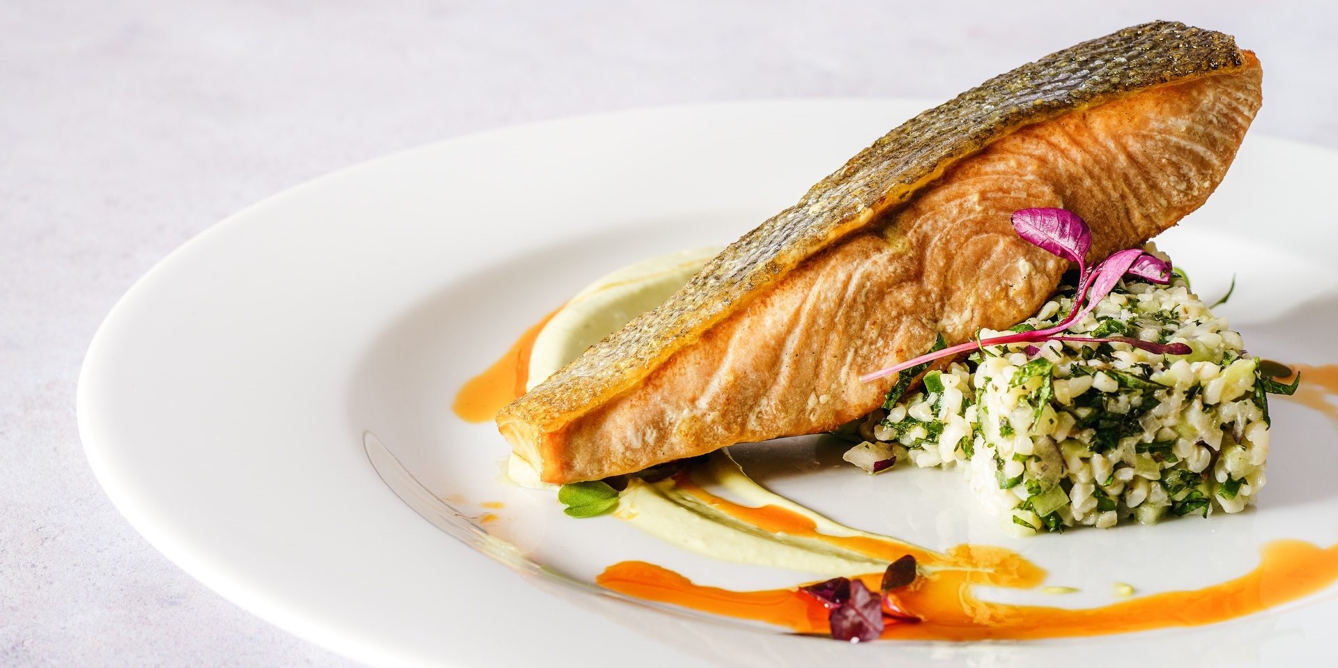 Photograph of a cooked salmon dish on a white plate